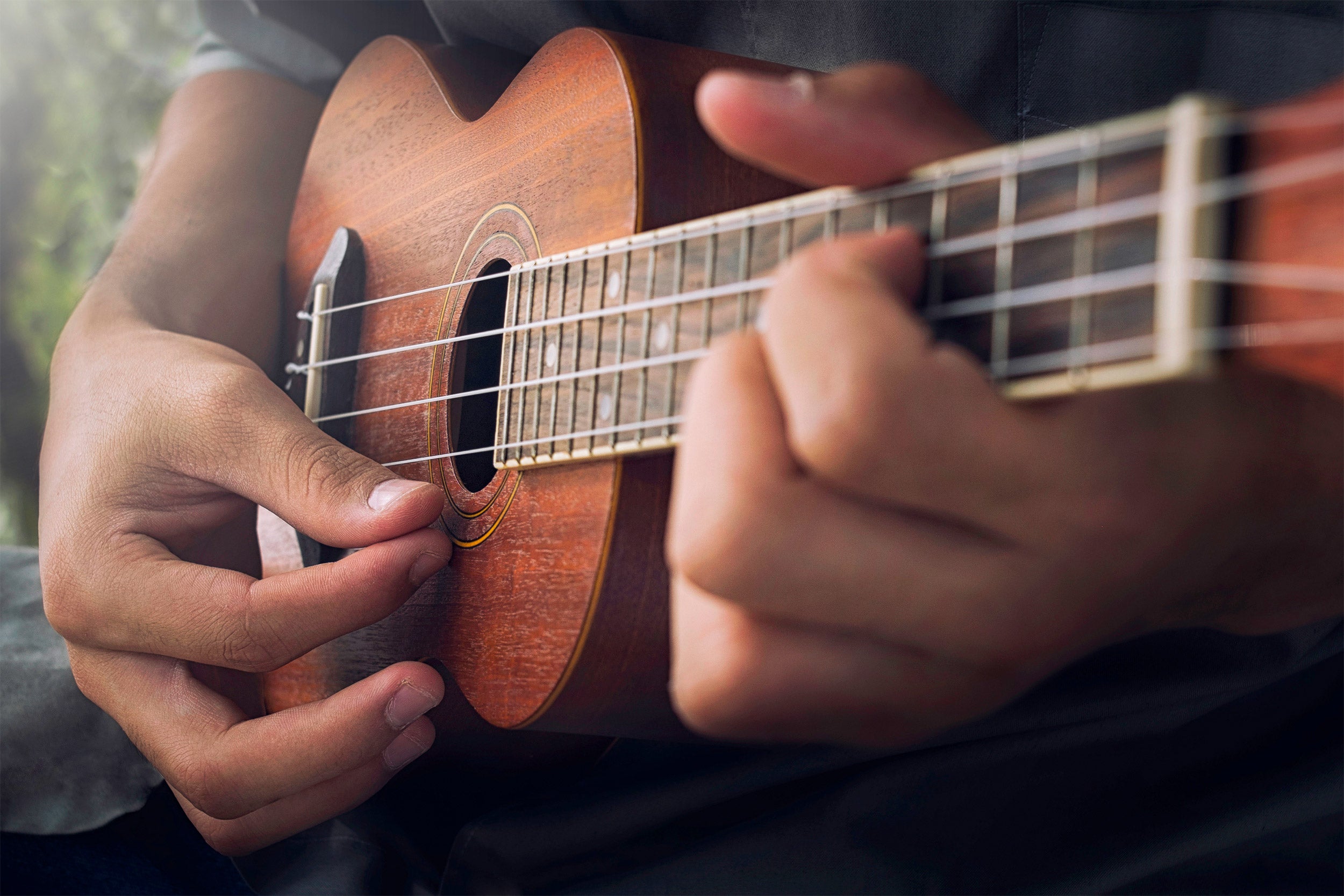 man playing ukulele